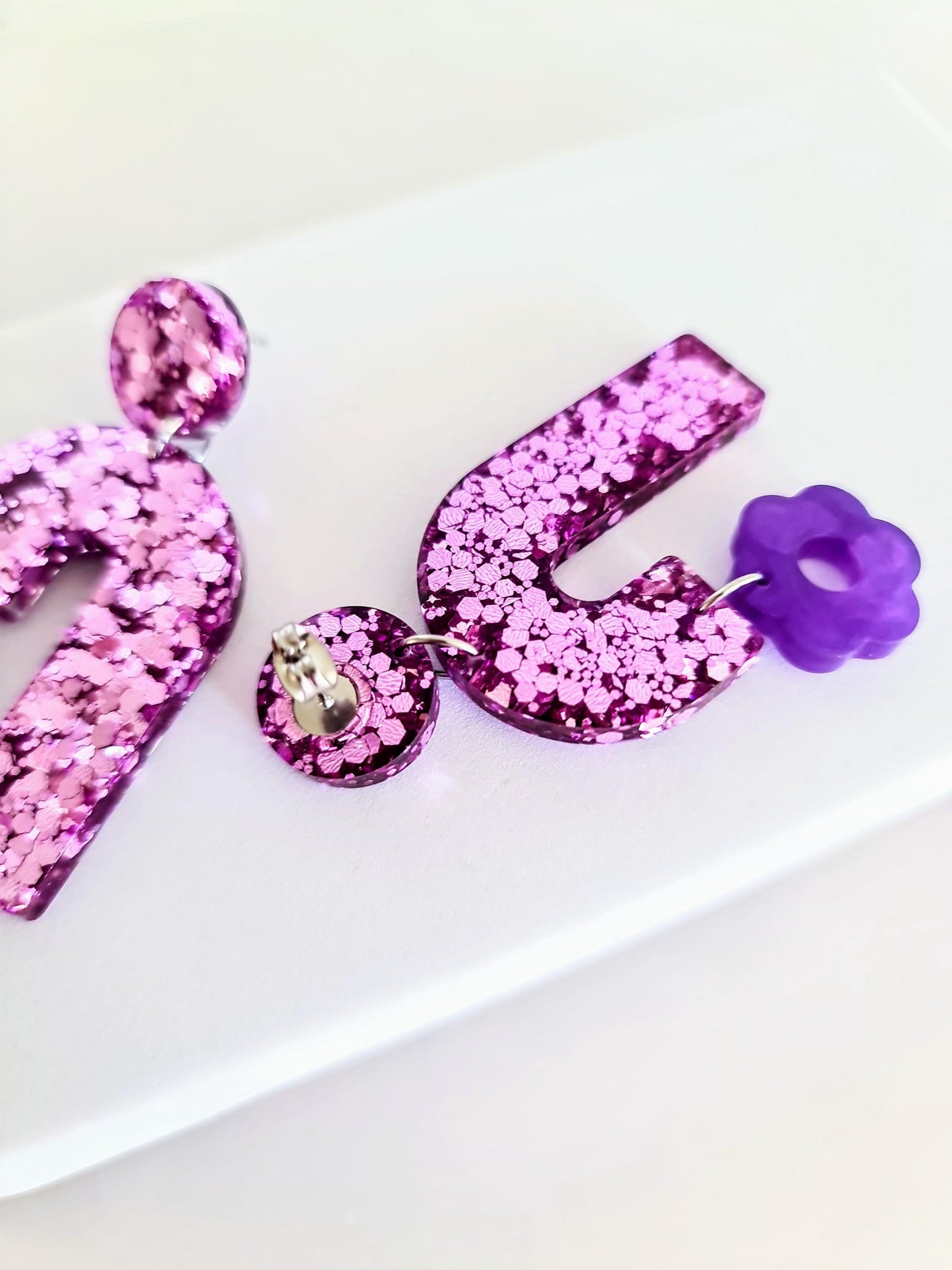 Blush Pink Arch Dangles with Purple Flower, Pink Glitter Resin, Purple Flower Charm, Statement Stainless Steel Earrings