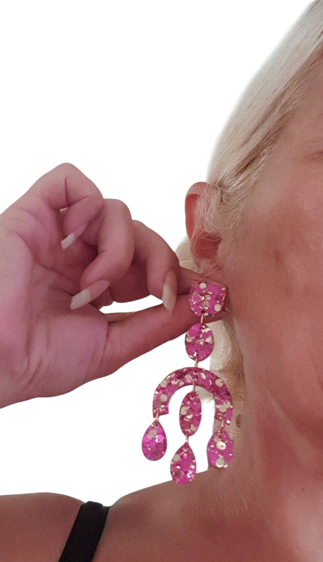 Silver and Resin Designs oversized pink and gold glitter resin chandelier earrings worn on a woman's ear