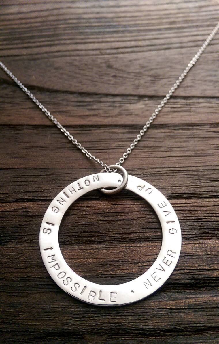 Hand Stamped Circle Necklace "Nothing is impossible . Never Give Up " Ready to post. - Silver and Resin Designs