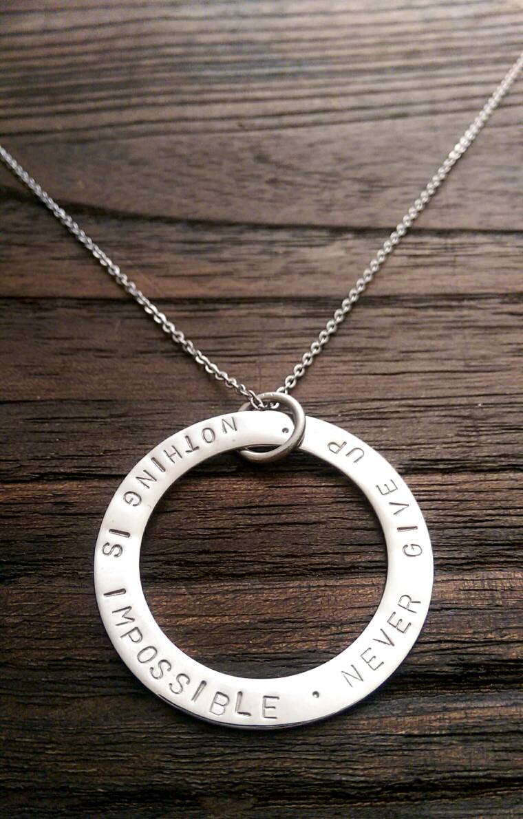 Hand Stamped Circle Necklace "Nothing is impossible . Never Give Up " Ready to post. - Silver and Resin Designs