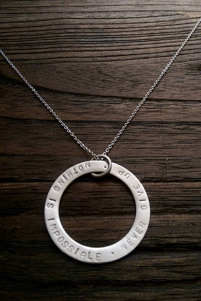 Hand Stamped Circle Necklace "Nothing is impossible . Never Give Up " Ready to post. - Silver and Resin Designs