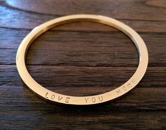 Gold Hand stamped Bangle Personalised Love You More Bangle Stainless Steel. Ready to post. Size Small 62mm inner diameter.