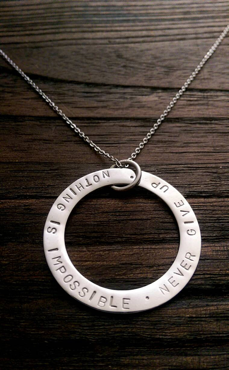 Hand Stamped Circle Necklace "Nothing is impossible . Never Give Up " Ready to post. - Silver and Resin Designs